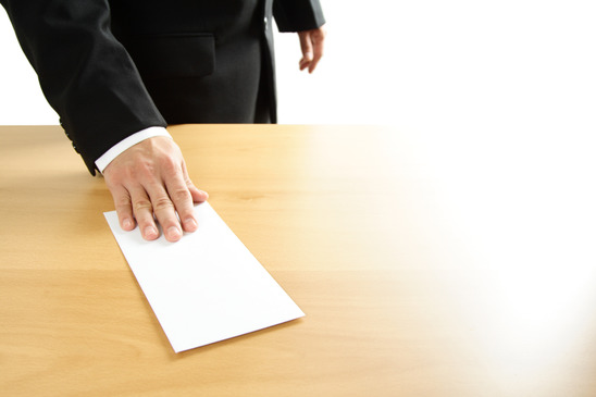 A businessman handing in a blank envelope