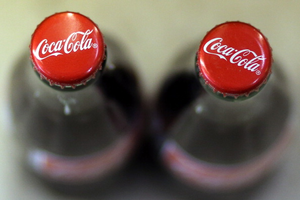 SAN FRANCISCO, CA - APRIL 16:  Bottles of Coca Cola are displayed at a market on April 16, 2013 in San Francisco, California.  Share prices of Coca Cola Co. surged as much as 5.8% today after the company reported better than expected first quarter profits. The stock surge is the largest intraday gain for Coca Cola since February 2009.  (Photo by Justin Sullivan/Getty Images)